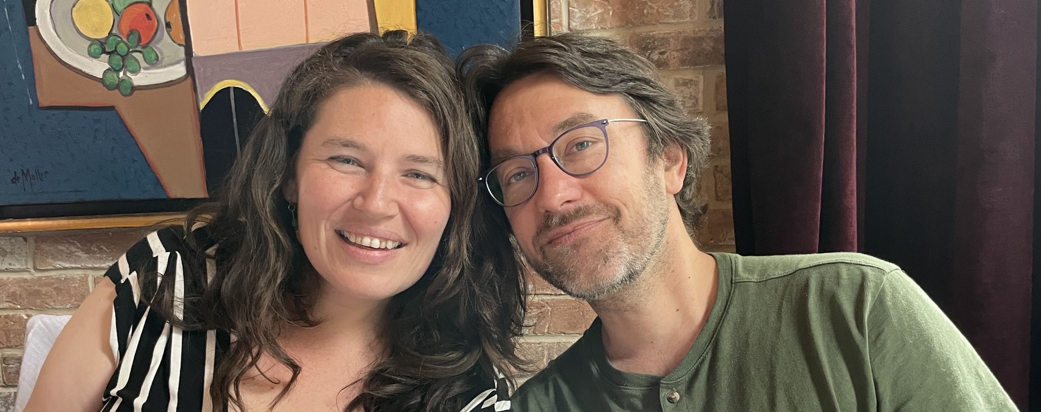 Meg and Kevin smiling at you