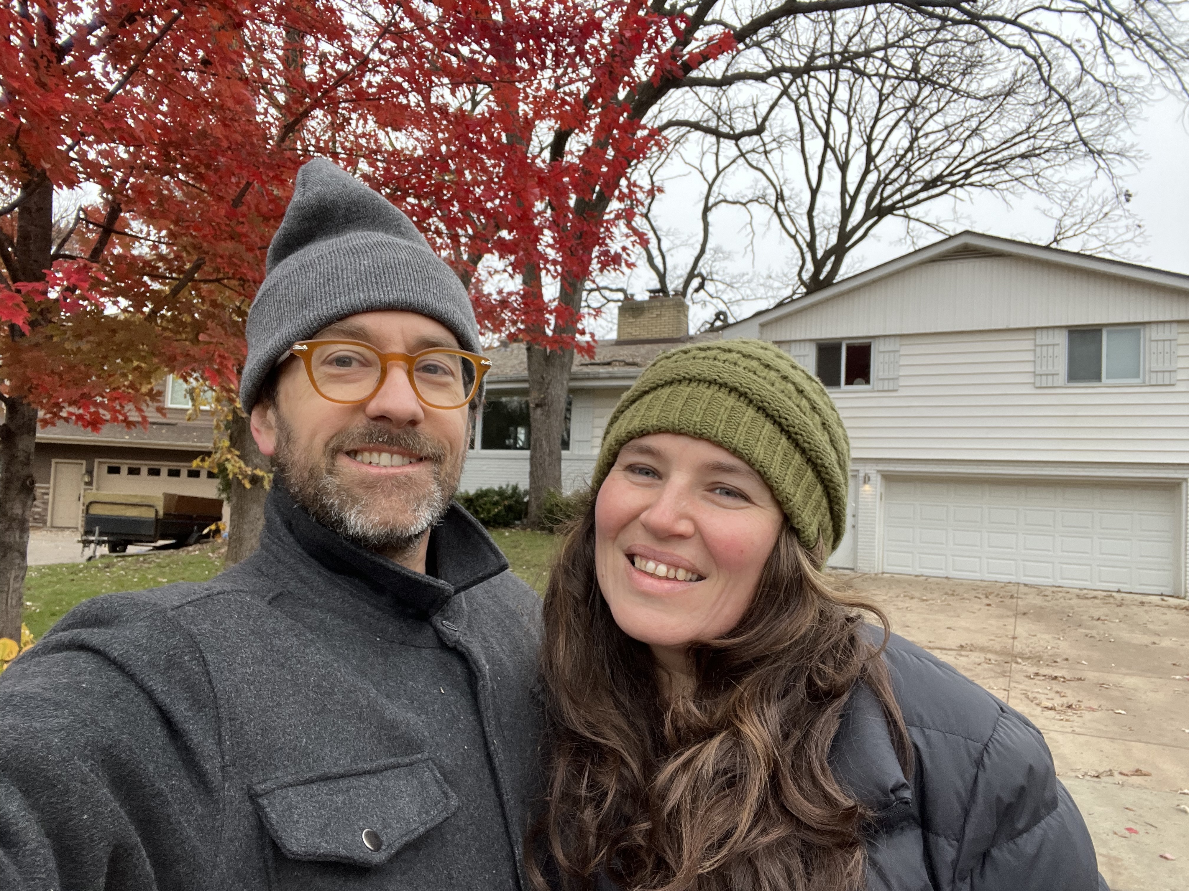 Meg and Kevin wearing winter hats, smiling